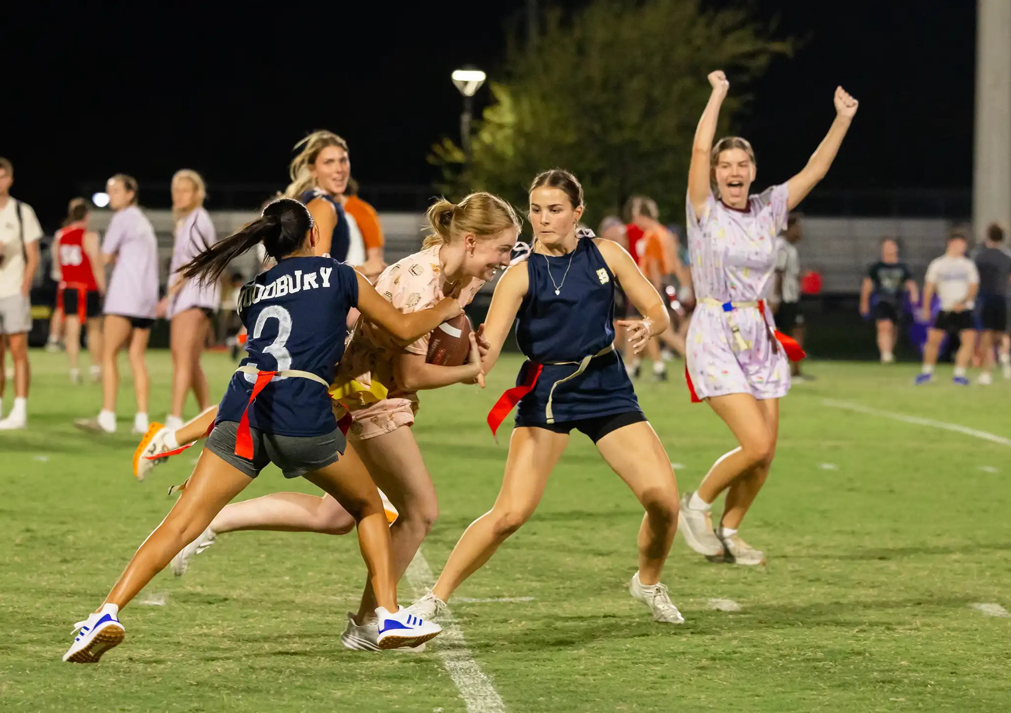 Students playing a game of intramural flag football.