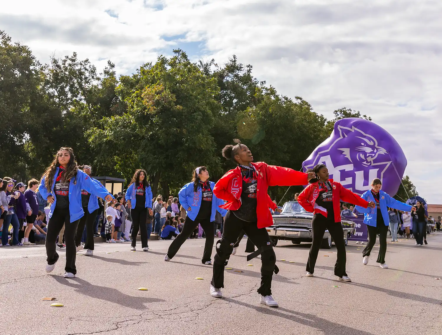 Omicron Xi Chi members perform a dance routine during the Homecoming Parade.