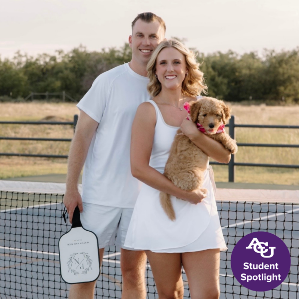 Nick and wife smiling with dog