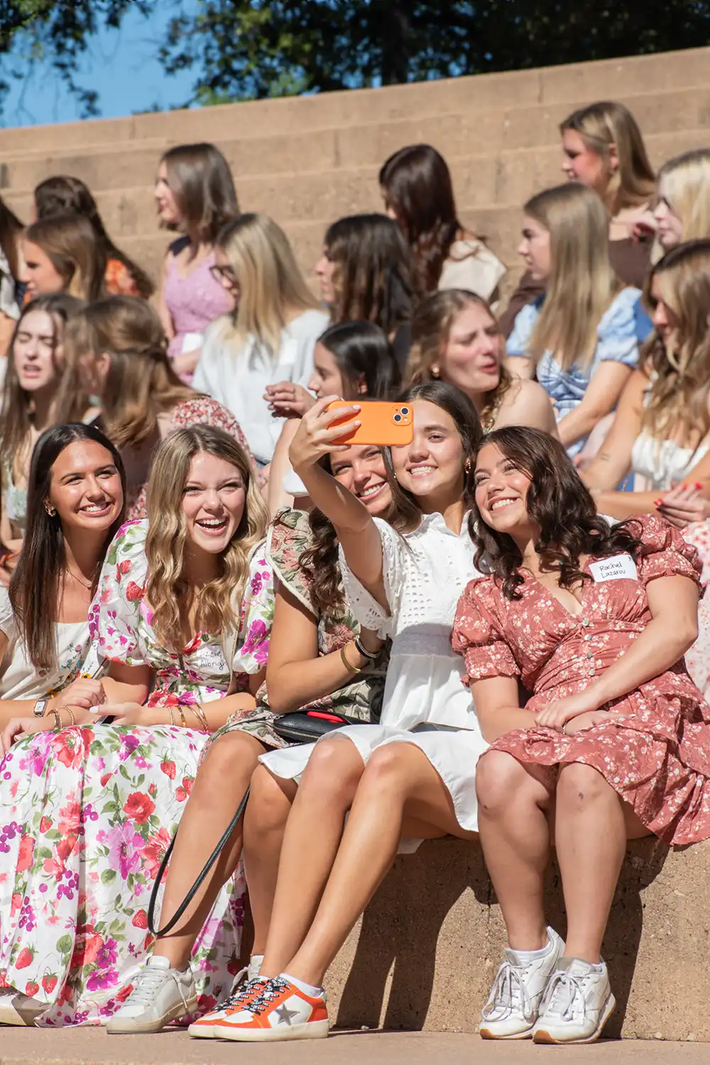 Students snap a group selfie at a sorority tea.