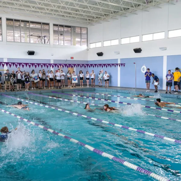 Students spectate a race in the swimming pool.