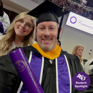 Bucky and daughter posing with his diploma.