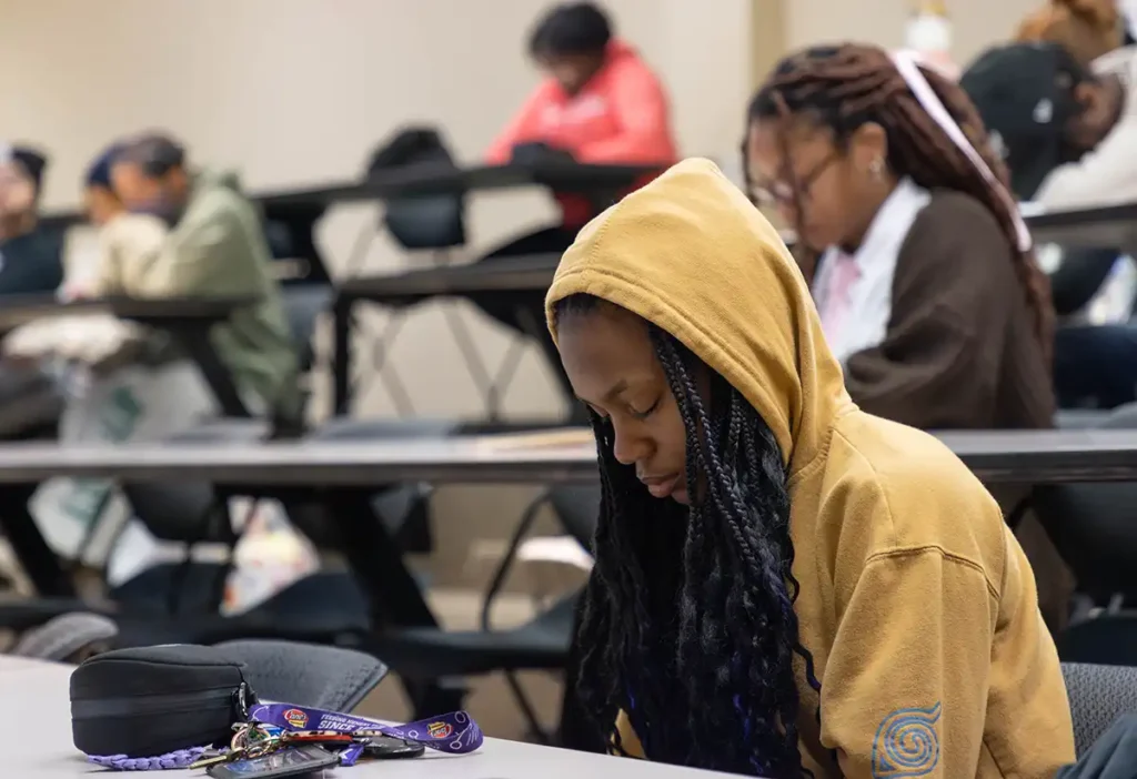 Students pray during a small group chapel.