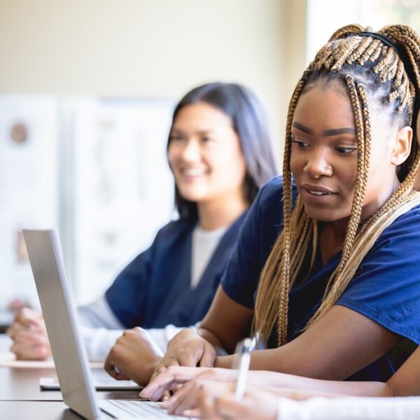 Nursing students haring a laptop