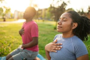 Couple doing yoga together outside