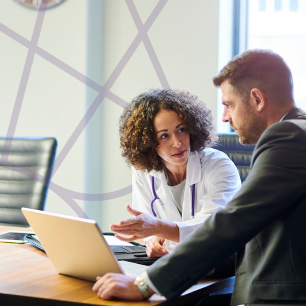 Healthcare Administrator sitting with nurse