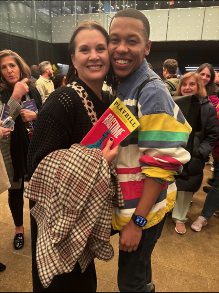 Photo of Dawne Swearingen-Meeks and Eean Cochran in a theatre lobby. Swearengen-Meeks holds a Ragtime playbill.