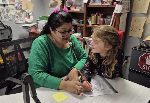 Rose Delgado teaching one of her students. 