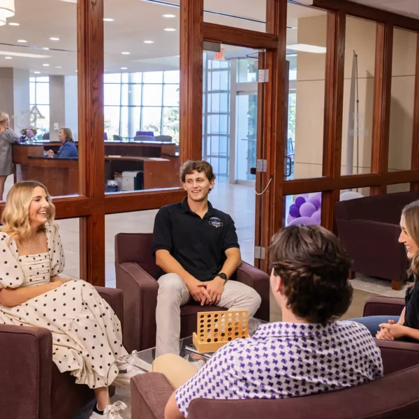 Admissions counselors chat with visitors during a campus visit.