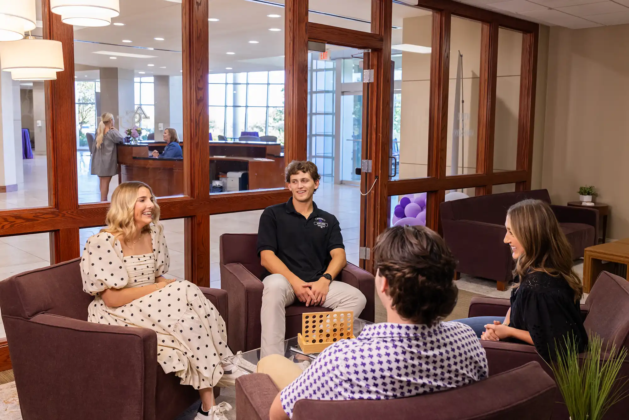 Admissions counselors chat with visitors during a campus visit.