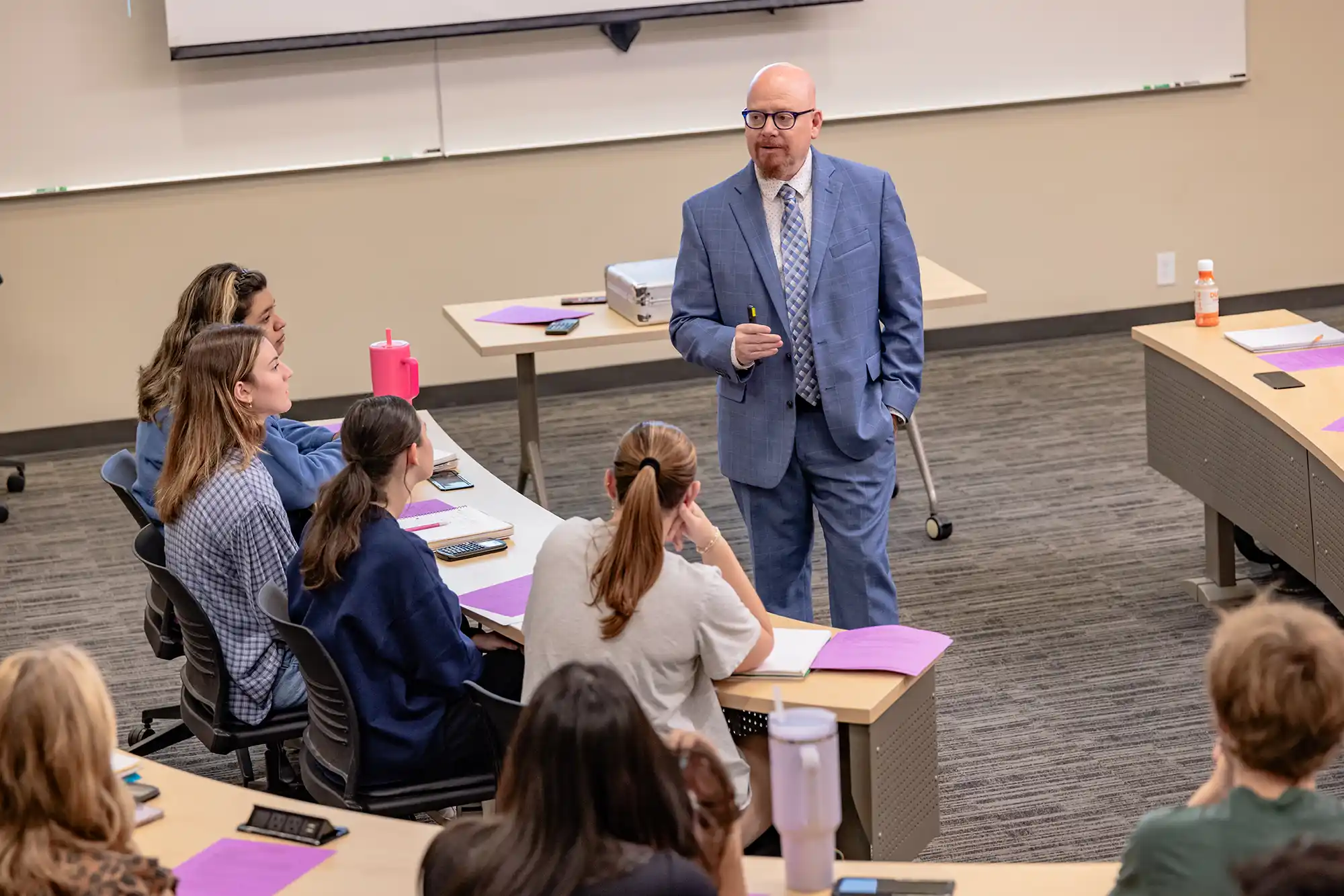 A professor lectures students in a College of Business Administration classroom.
