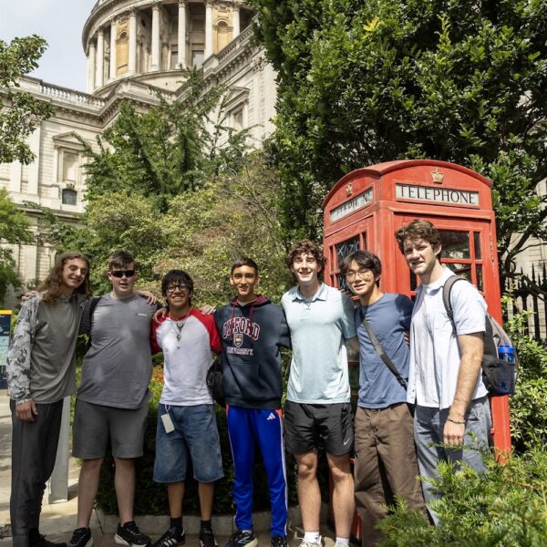 Rising Scholar students in Oxford by red telephone booth.