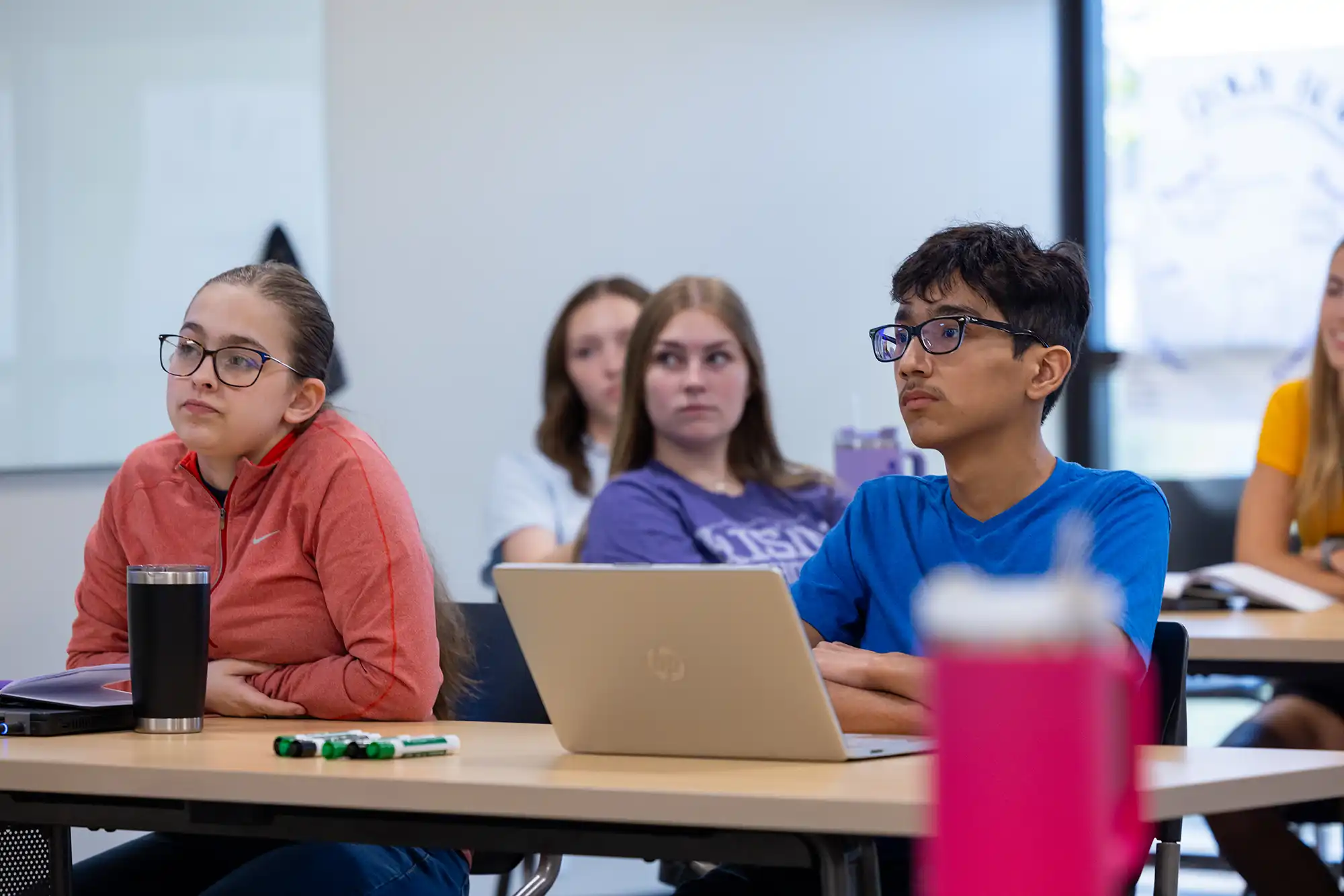Students in a Rising Scholars classroom listen to a lesson.