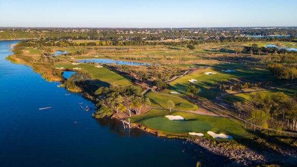 Overhead shot of a golf course next to a lake