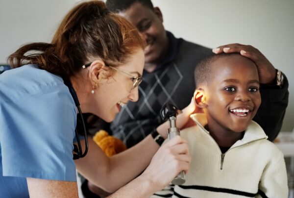 Boy getting ear checked by audiologist