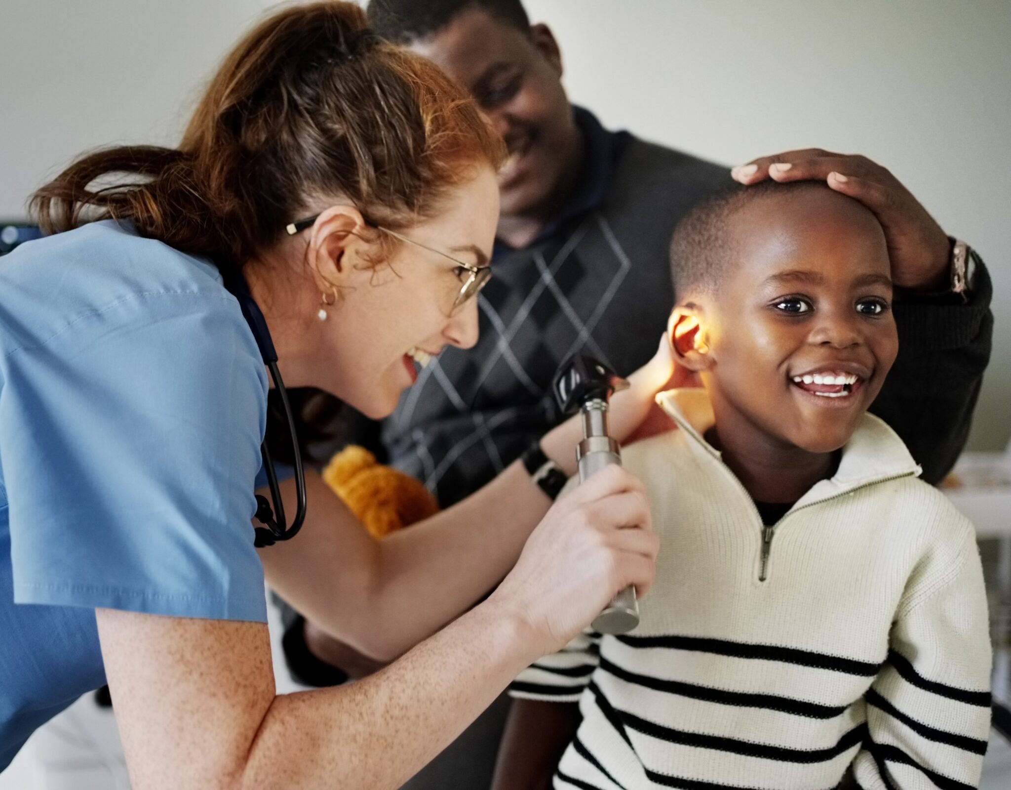 Boy getting ear checked by audiologist