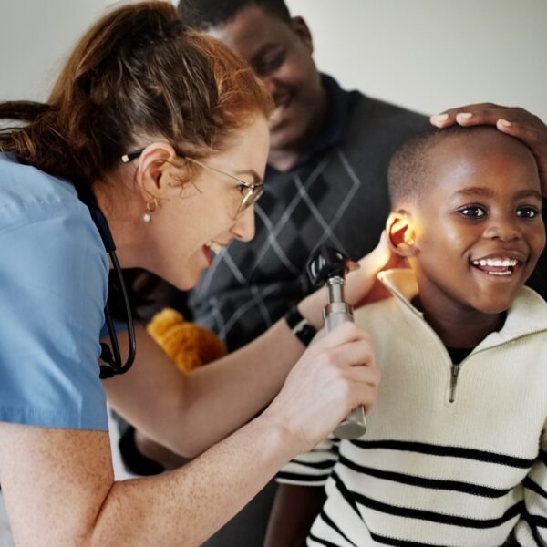 Boy getting ear checked by audiologist